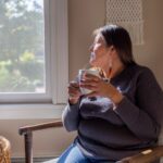 Native American woman looking out a window