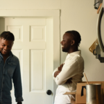 LGBTQ+ couple laughing in a kitchen